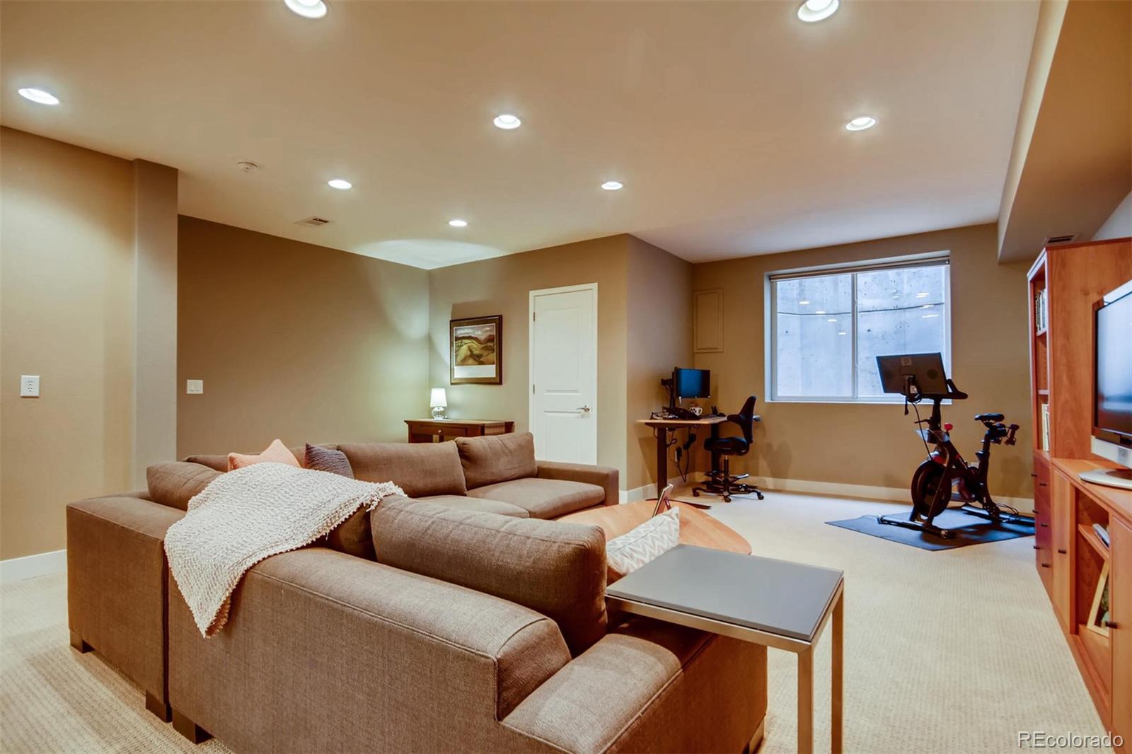 3231 Perry Street Denver, CO 80212 - Photo 25 of 36 a living room with furniture a large window and gym equipment