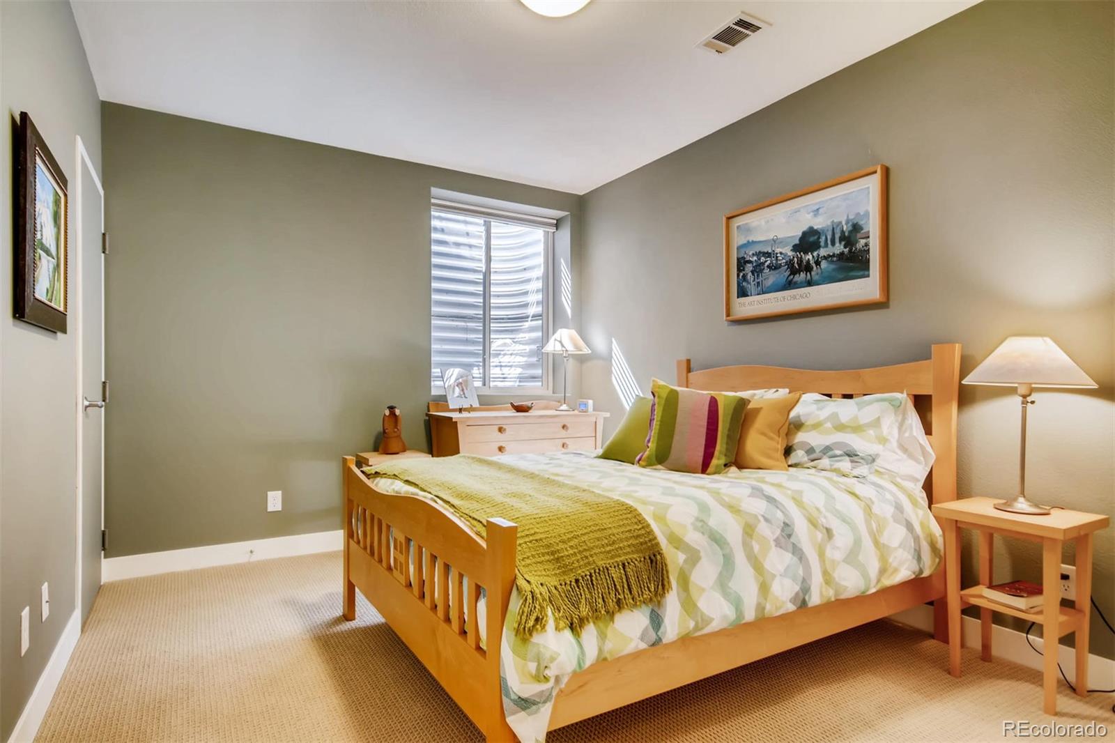 3231 Perry Street Denver, CO 80212 - Photo 26 of 36 a large bed sitting in a bedroom next to a lamp