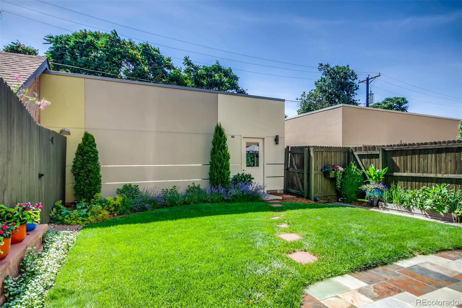 3231 Perry Street Denver, CO 80212 - Photo 29 of 36 a view of a house with a yard and plants
