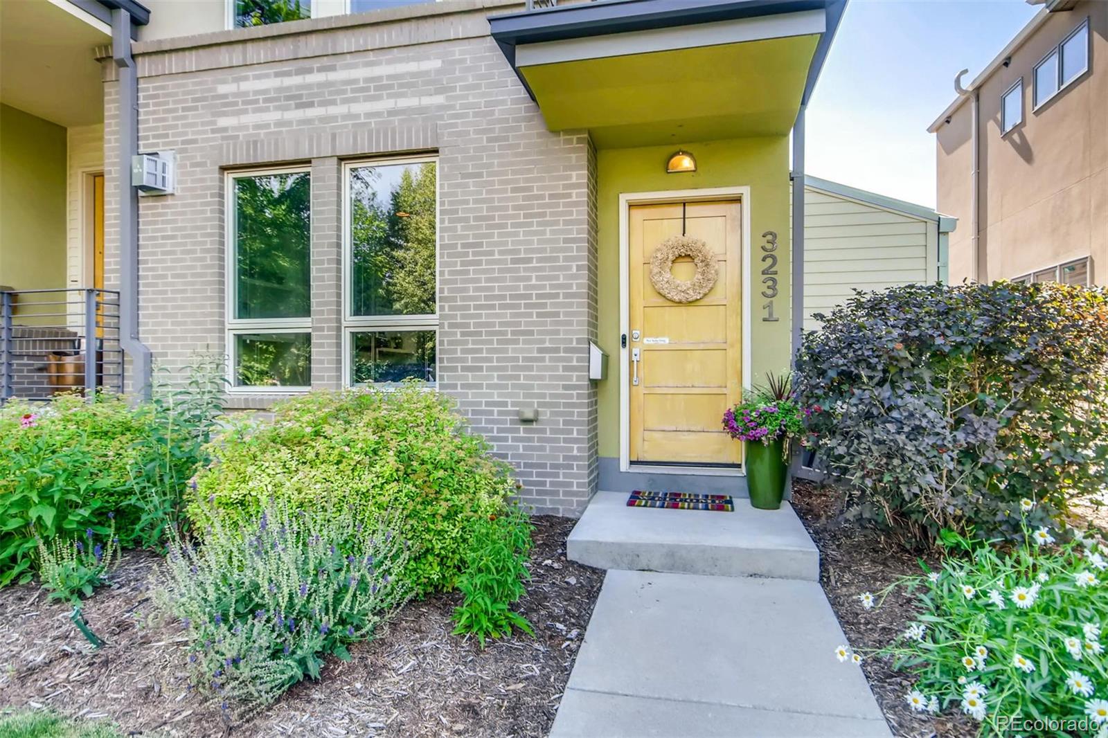 3231 Perry Street Denver, CO 80212 - Photo 3 of 36 a front view of a house having yard