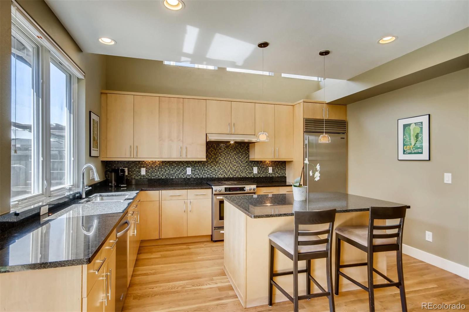 3231 Perry Street Denver, CO 80212 - Photo 10 of 36 a kitchen with stainless steel appliances granite countertop wooden cabinets a stove top oven a sink and dishwasher