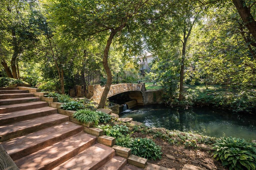 4851 Cedar Springs Road, Unit 383 Dallas, TX 75219 - Photo 15 of 19 a backyard of a house with lots of green space and lake view