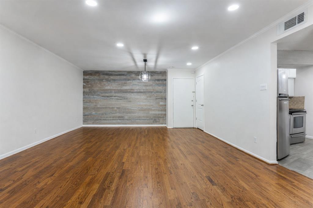 4851 Cedar Springs Road, Unit 383 Dallas, TX 75219 - Photo 5 of 19 a view of empty room with wooden floor