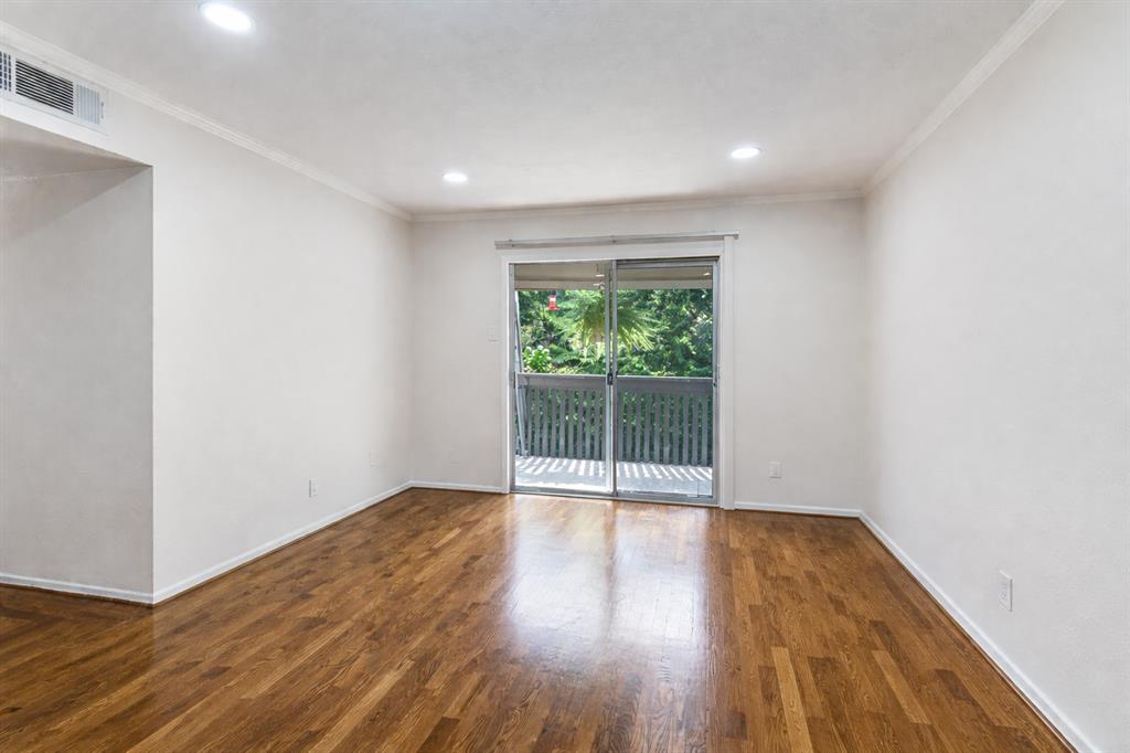 4851 Cedar Springs Road, Unit 383 Dallas, TX 75219 - Photo 6 of 19 a view of empty room with wooden floor and fan