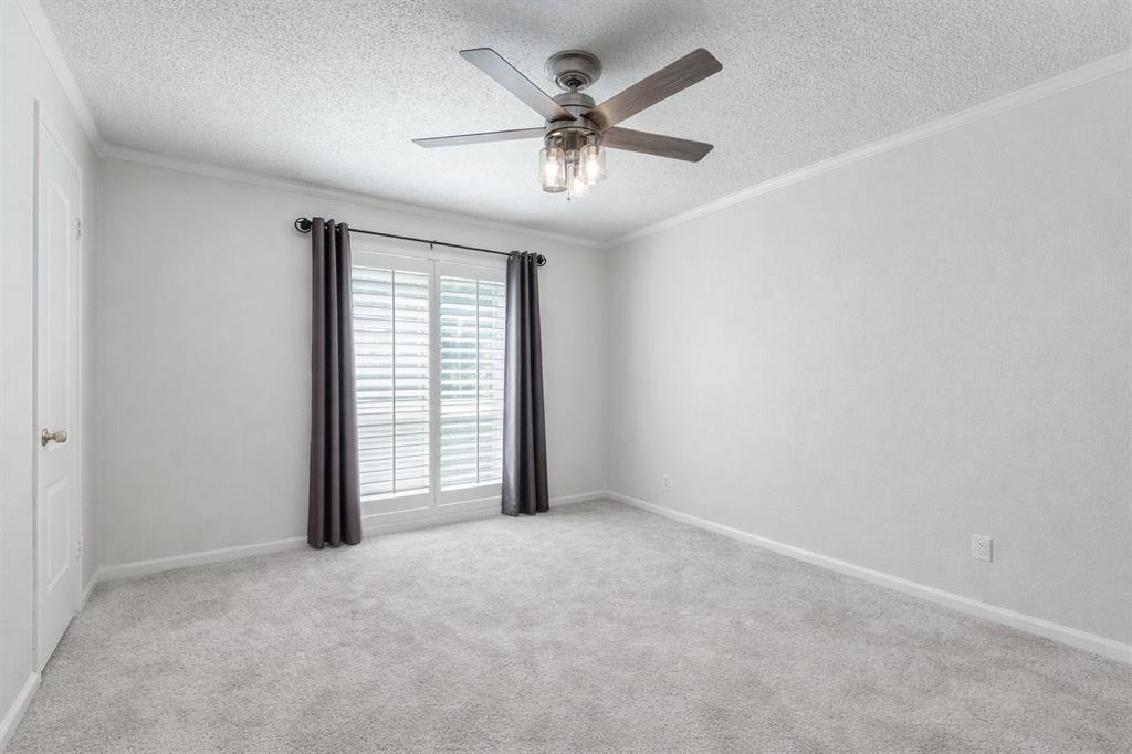 4851 Cedar Springs Road, Unit 383 Dallas, TX 75219 - Photo 10 of 19 an empty room with windows and ceiling fan