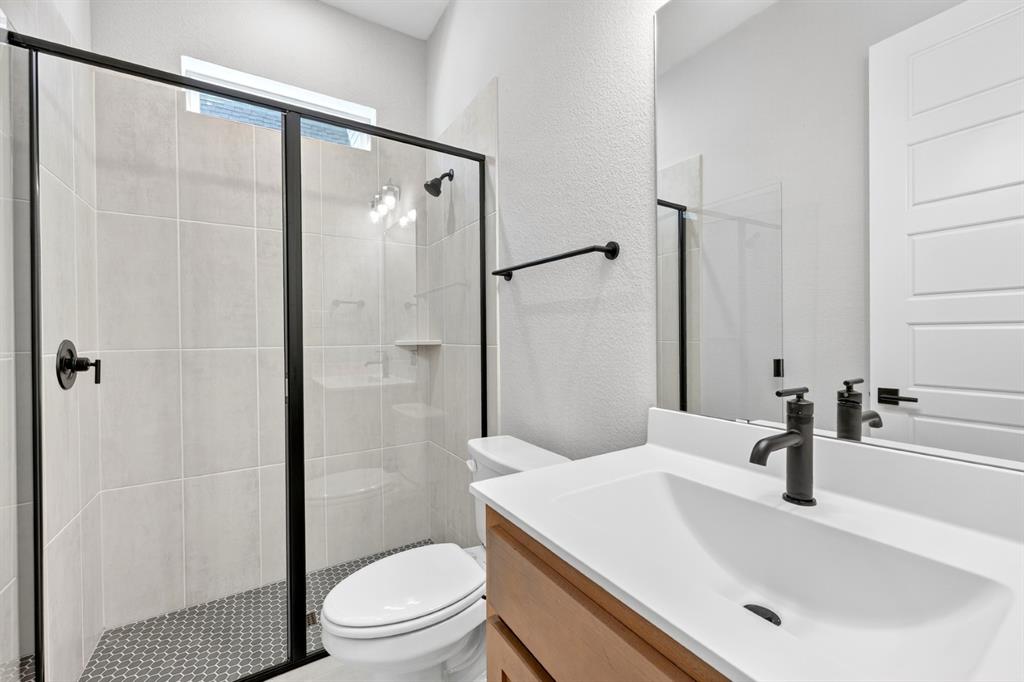 2109 Chance Lane Northlake, TX 76247 - Photo 21 of 36 a bathroom with a sink a toilet and shower
