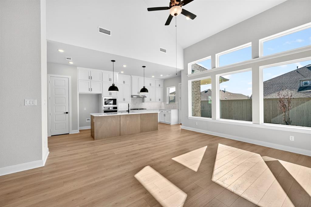 2109 Chance Lane Northlake, TX 76247 - Photo 32 of 36 a living room with kitchen island furniture and a large window