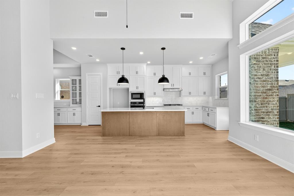 2109 Chance Lane Northlake, TX 76247 - Photo 33 of 36 a large kitchen with stainless steel appliances kitchen island a large counter top and a floors