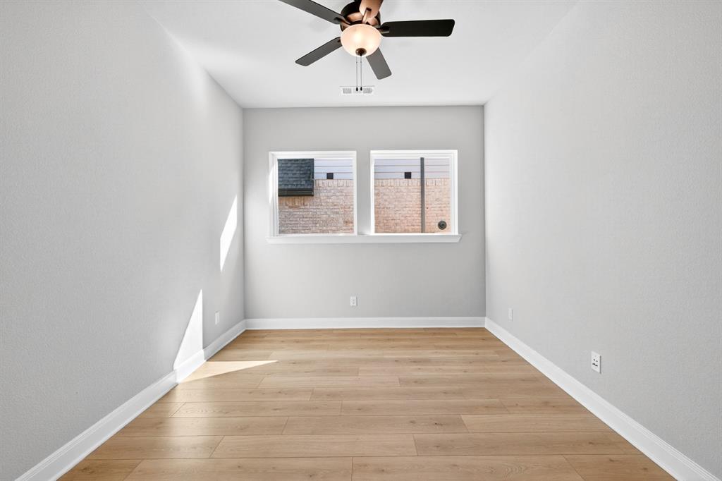 2109 Chance Lane Northlake, TX 76247 - Photo 7 of 36 an empty room with wooden floor chandelier fan and windows