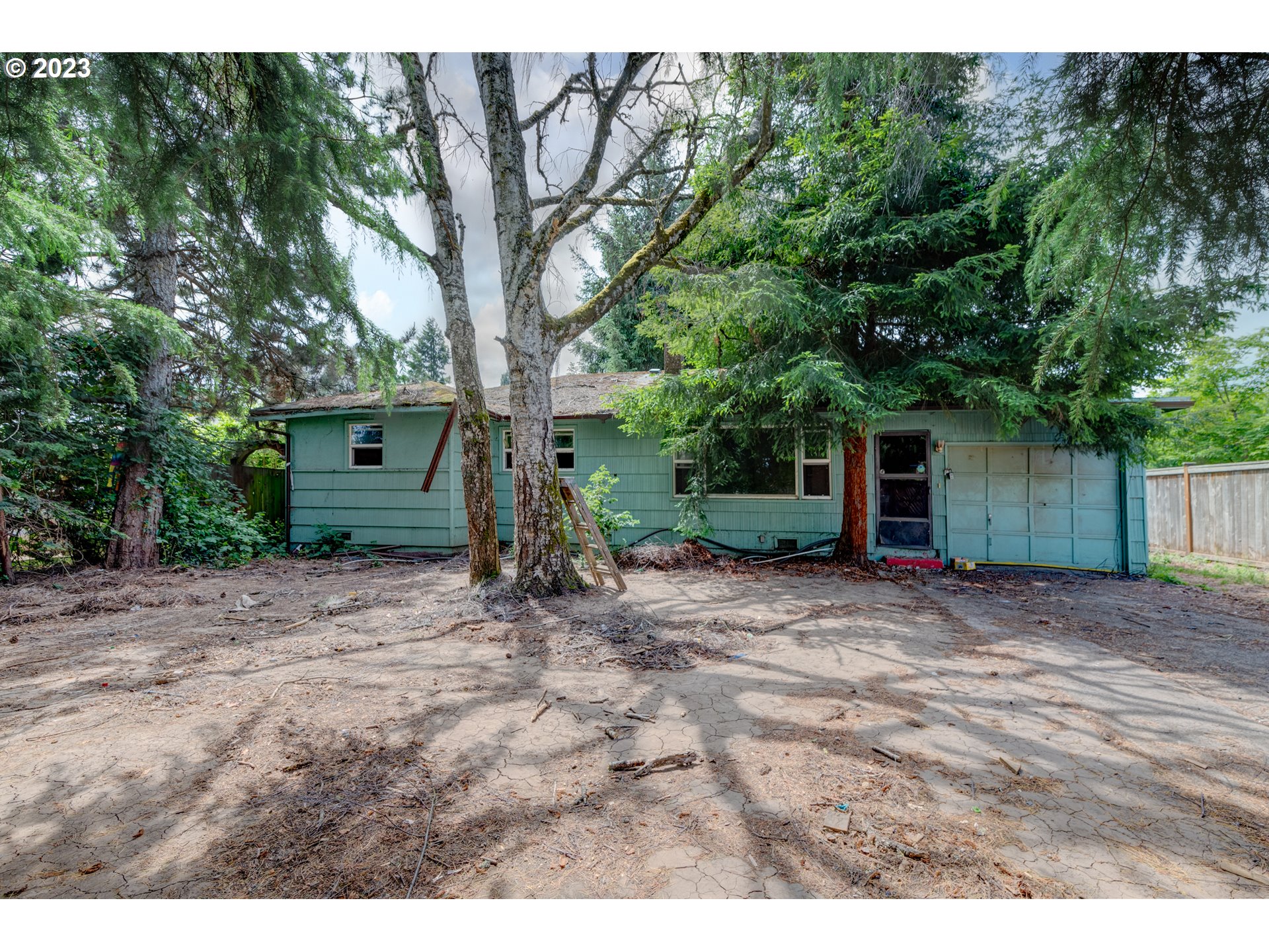 a view of a house with a tree in the background