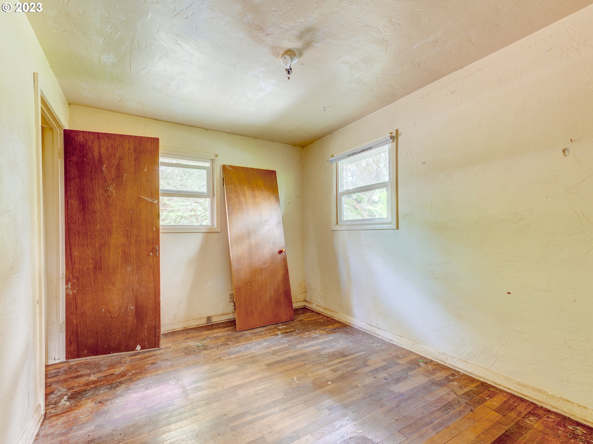 3350 Oriole Street Springfield, OR 97477 - Photo 9 of 15 an empty room with wooden floor and windows