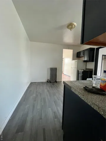 a room with a sink and a wooden floor