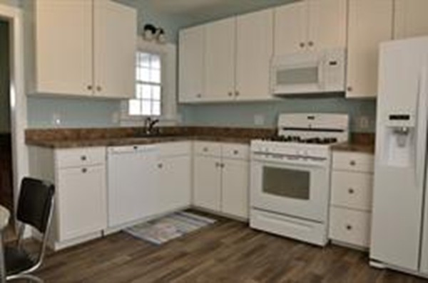 111 Turner Road Scituate, MA 02066 - Photo 8 of 24 a kitchen with granite countertop white cabinets and white appliances