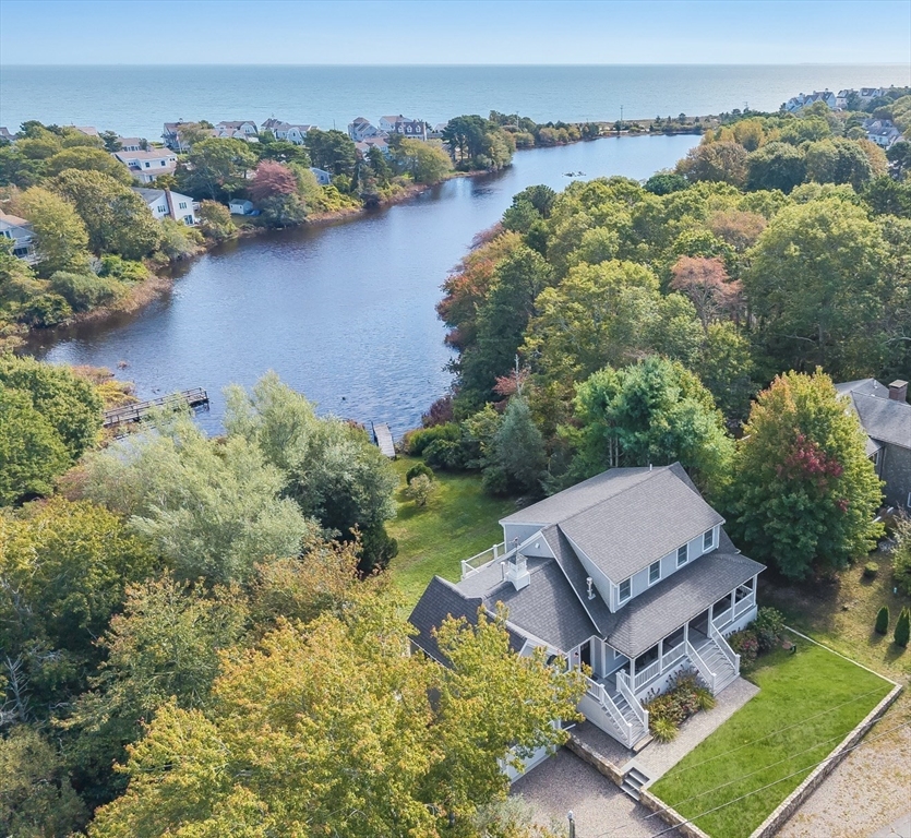an aerial view of a house with a garden and lake view