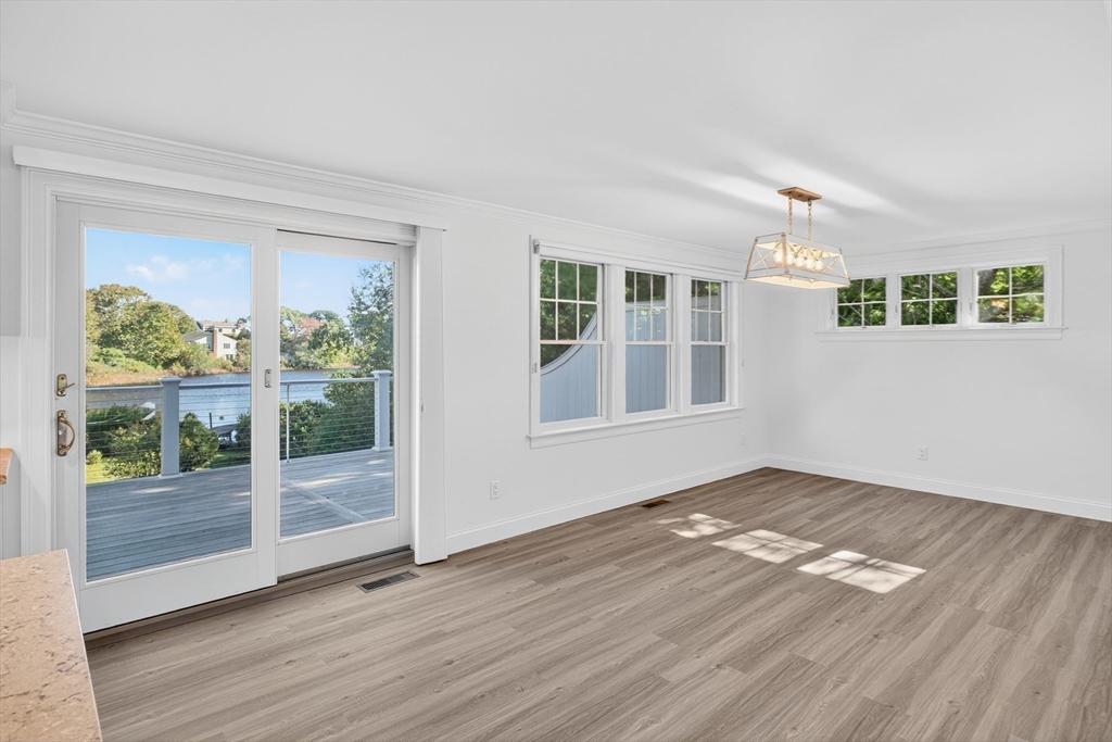 128 Uncle Percy's Road Mashpee, MA 02649 - Photo 11 of 42 a view of an empty room with wooden floor and a window