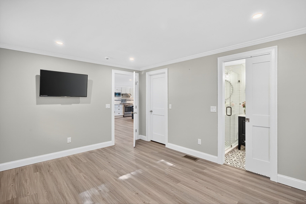 128 Uncle Percy's Road Mashpee, MA 02649 - Photo 12 of 42 a view of a livingroom with wooden floor and a flat screen tv