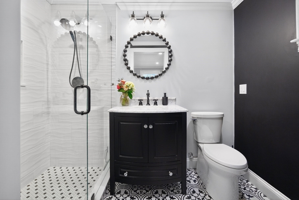 128 Uncle Percy's Road Mashpee, MA 02649 - Photo 14 of 42 a bathroom with a sink toilet and shower