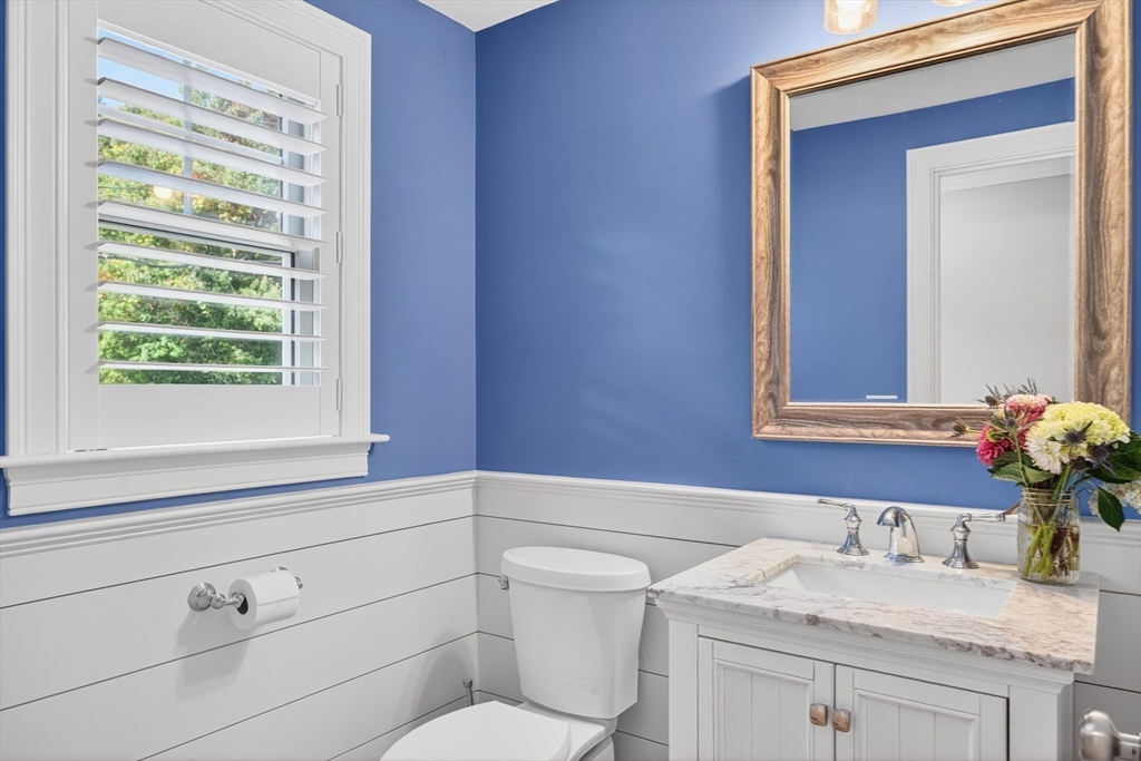 128 Uncle Percy's Road Mashpee, MA 02649 - Photo 17 of 42 a bathroom with a granite countertop sink vanity mirror and toilet