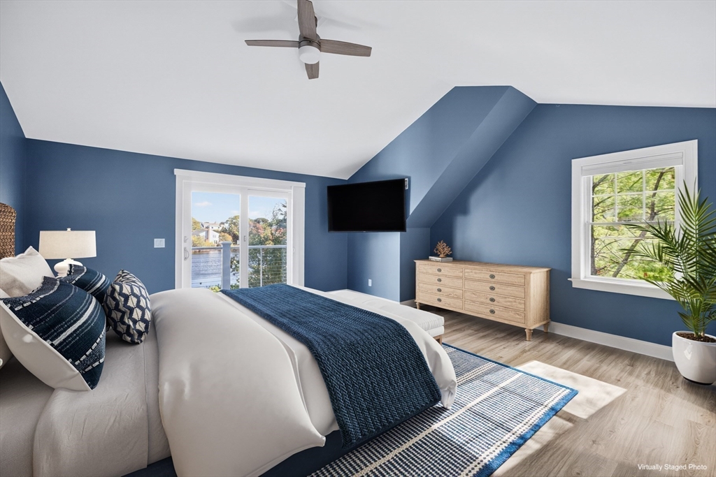 128 Uncle Percy's Road Mashpee, MA 02649 - Photo 22 of 42 a bedroom with a bed and wooden floor