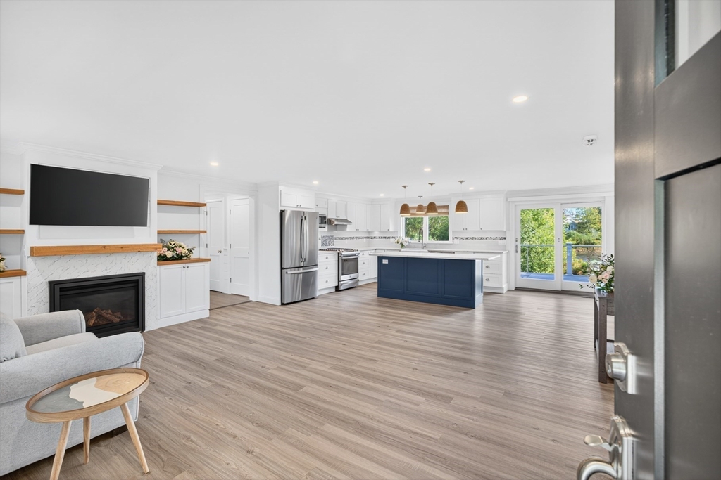 128 Uncle Percy's Road Mashpee, MA 02649 - Photo 5 of 42 a living room with furniture a fireplace and a flat screen tv