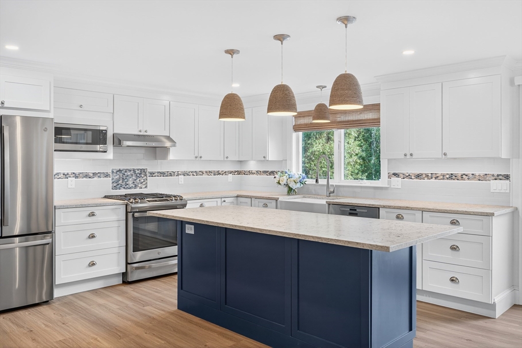 128 Uncle Percy's Road Mashpee, MA 02649 - Photo 7 of 42 a kitchen with cabinets a sink and appliances