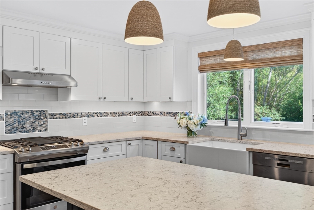 128 Uncle Percy's Road Mashpee, MA 02649 - Photo 8 of 42 a kitchen with a stove a sink and a refrigerator