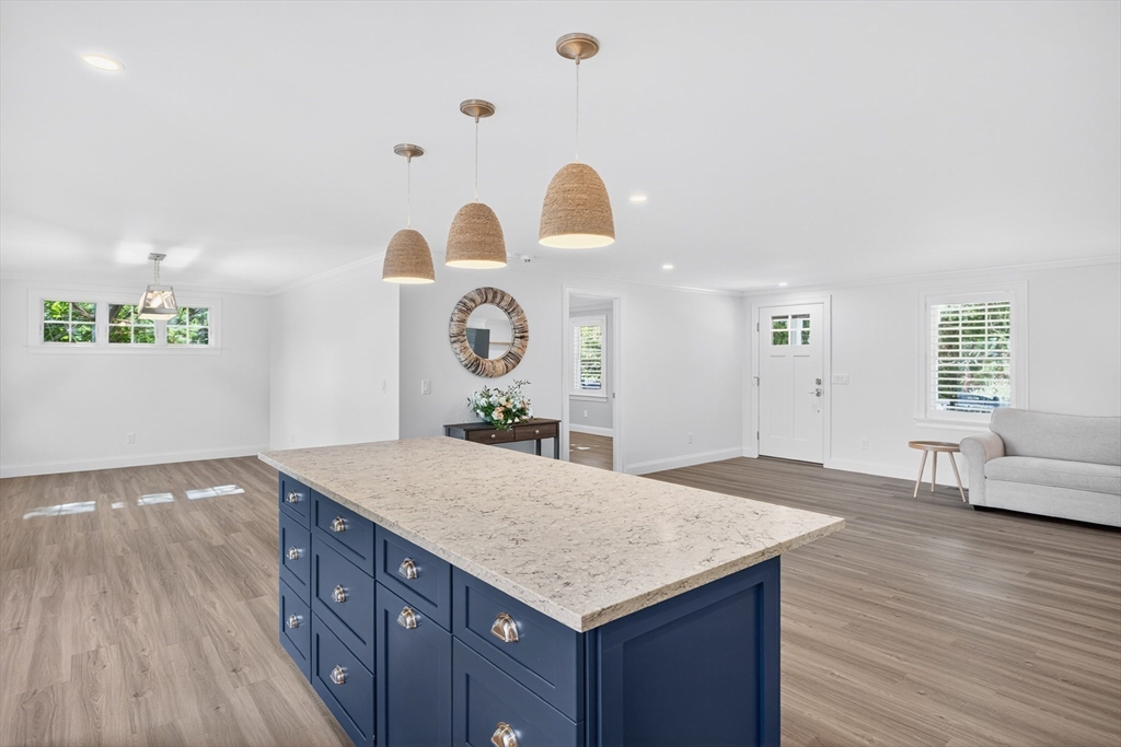 128 Uncle Percy's Road Mashpee, MA 02649 - Photo 10 of 42 a living room with kitchen island furniture and a window