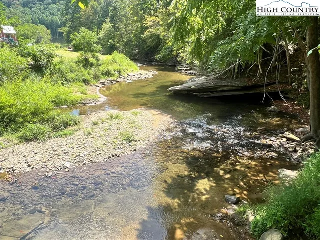 a view of a lake with lots of trees