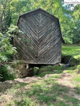 a backyard of a house with a yard and outdoor seating