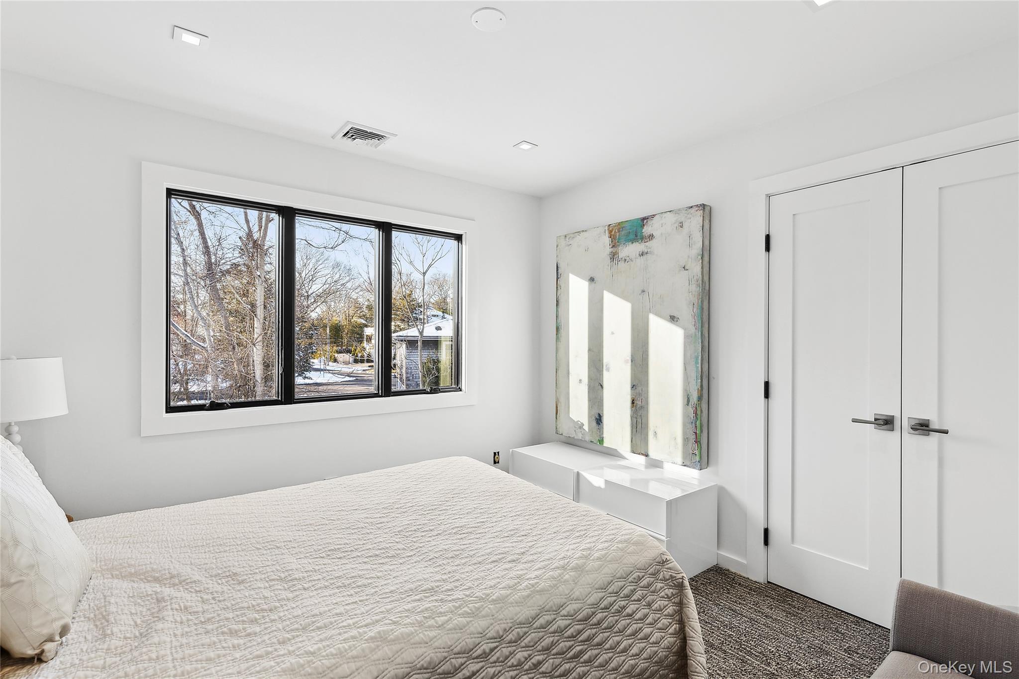 221 Redwood Road Sag Harbor, NY 11963 - Photo 14 of 19 a bedroom with a bed and a window