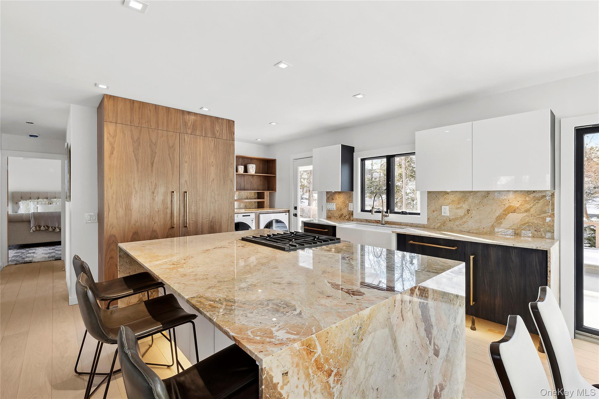 221 Redwood Road Sag Harbor, NY 11963 - Photo 8 of 19 a view of a kitchen with kitchen island a dining table and chairs