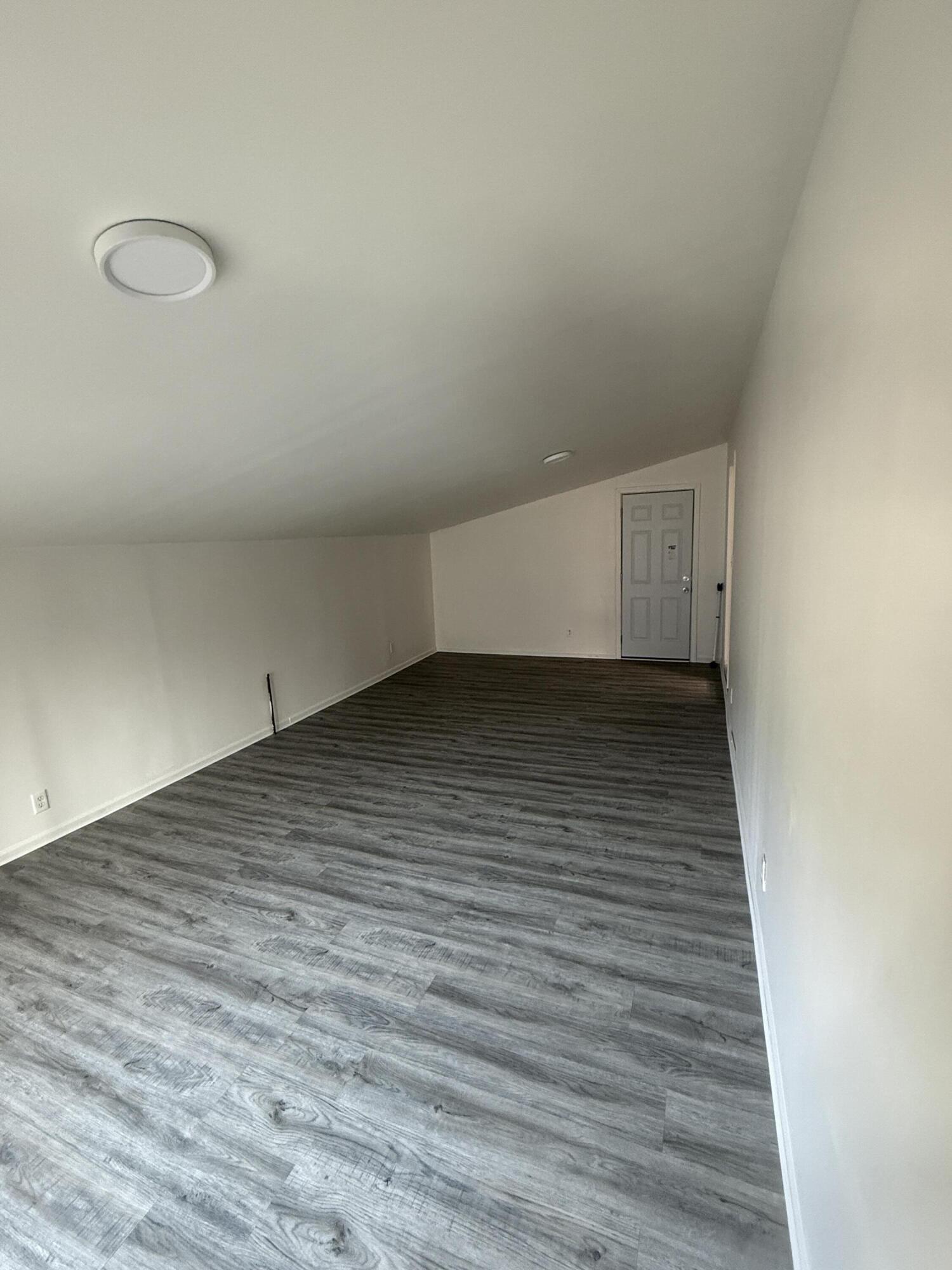7809 Indian Boundary Gary, IN 46403 - Photo 7 of 13 a view of an empty room and wooden floor