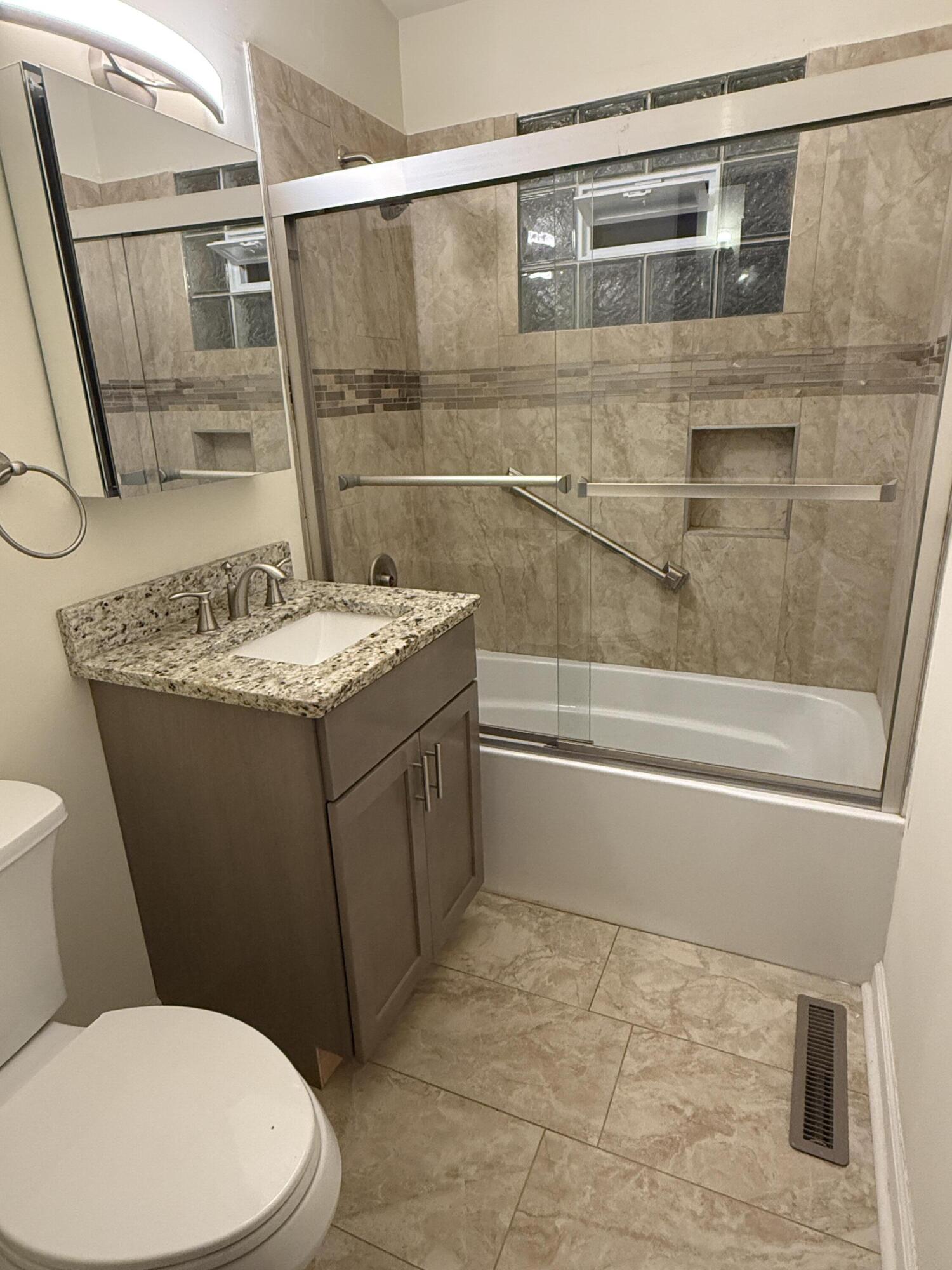 7809 Indian Boundary Gary, IN 46403 - Photo 8 of 13 a bathroom with a granite countertop sink toilet and shower