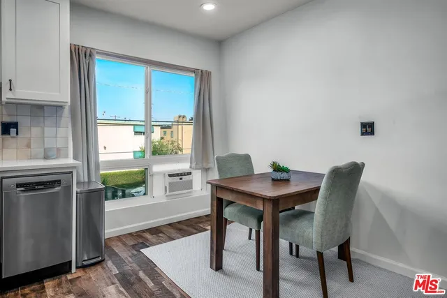 a view of a dining room with a table and chairs