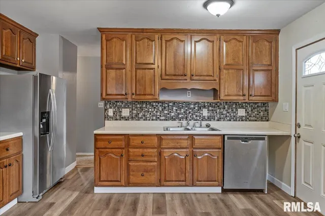 a kitchen with stainless steel appliances granite countertop a stove and a refrigerator