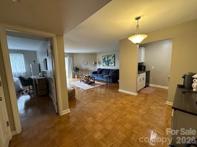 1323 Queens Road, Unit 313 Charlotte, NC 28207 - Photo 26 of 43 a view of livingroom with furniture and a chandelier