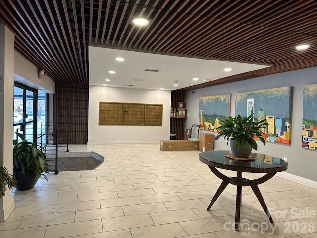 1323 Queens Road, Unit 313 Charlotte, NC 28207 - Photo 5 of 43 a lobby with furniture and a potted plant