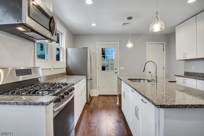 17 William Street, Unit B Summit, NJ 07901 - Photo 7 of 19 a kitchen with granite countertop stainless steel appliances and wooden cabinets