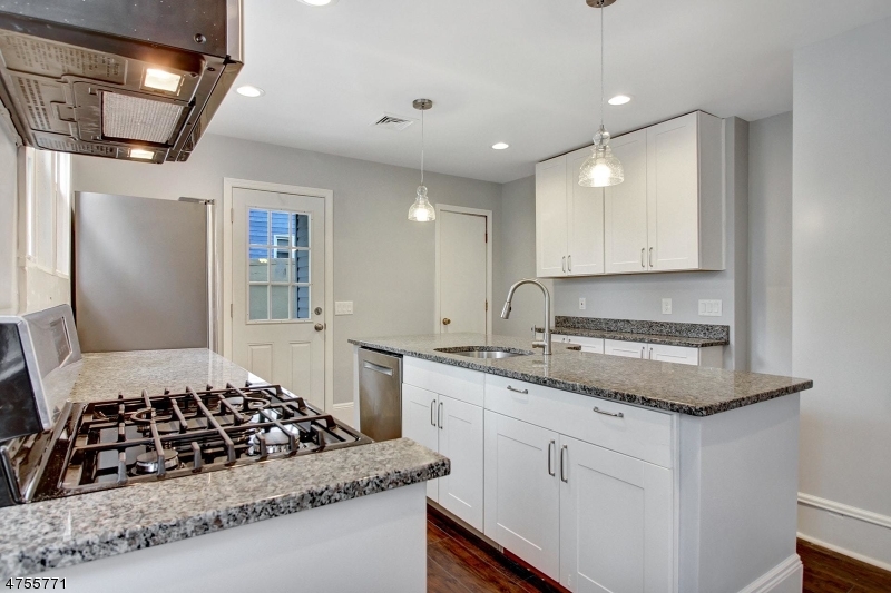 17 William Street, Unit B Summit, NJ 07901 - Photo 8 of 19 a kitchen with stainless steel appliances granite countertop a sink stove and cabinets