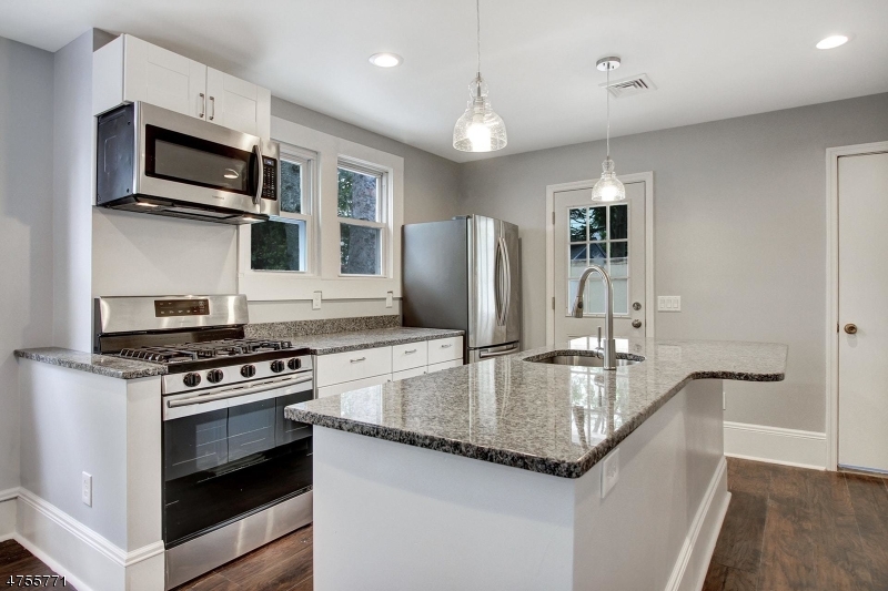 17 William Street, Unit B Summit, NJ 07901 - Photo 9 of 19 a kitchen with stainless steel appliances granite countertop a refrigerator a stove and a sink