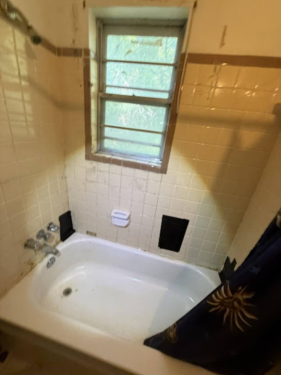 3960 West Union Road Millington, TN 38053 - Photo 8 of 10 a bathroom with a bathtub and a window