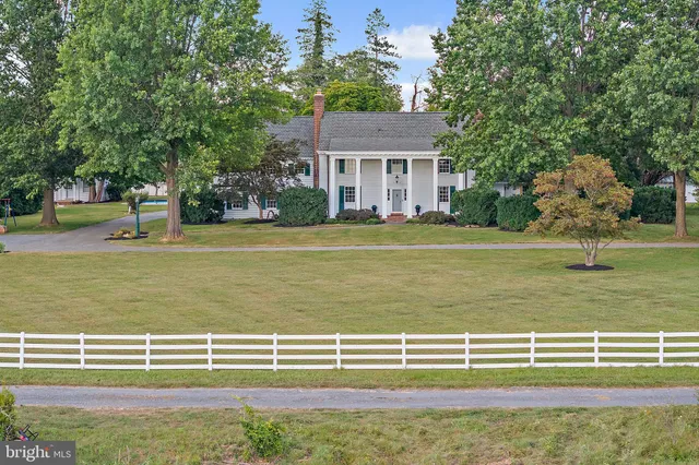 an aerial view of a house with swimming pool and garden
