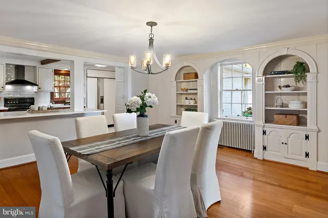 a view of a house with a small yard and a large tree