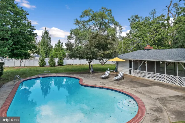 a house with swimming pool in front of it