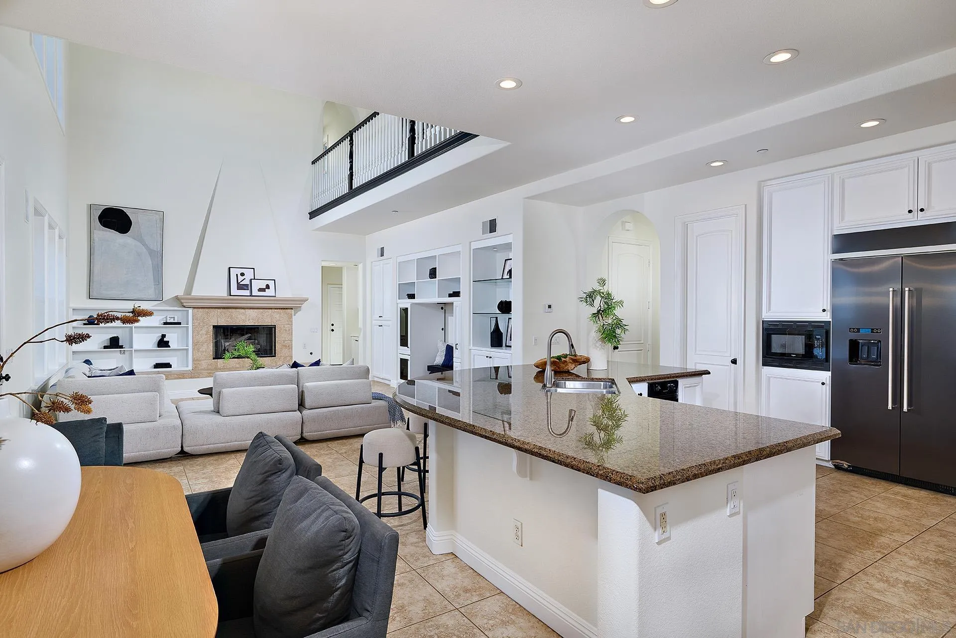 1664 Aryana Drive Encinitas, CA 92024 - Photo 10 of 38 a large kitchen with a table chairs refrigerator and microwave