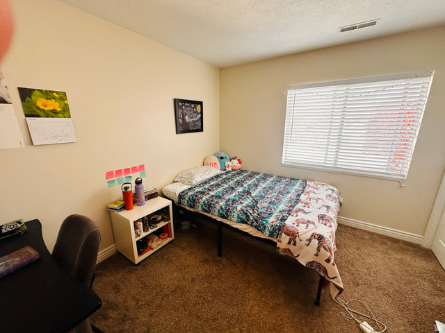 1559 Riverside Avenue, Unit 9 Provo, UT 84604 - Photo 7 of 12 Bedroom featuring dark carpet and a textured ceiling