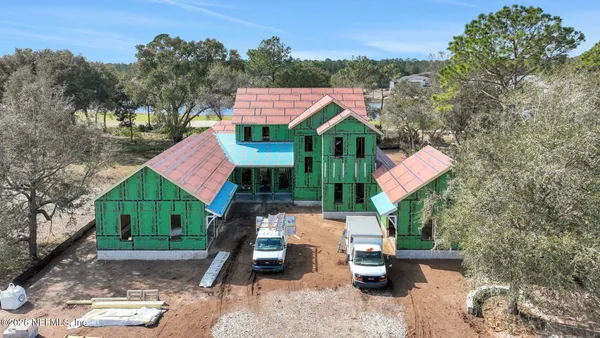 an aerial view of residential houses with outdoor space