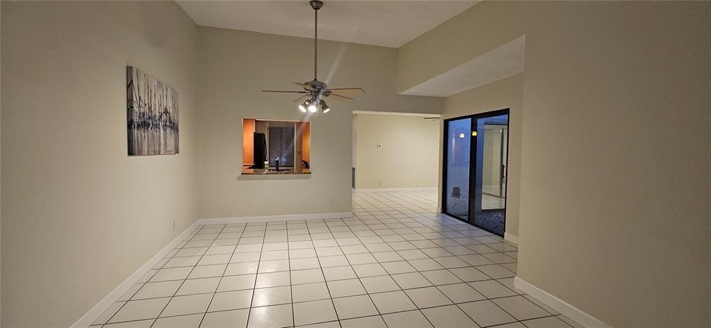 814 Northwest 79th Terrace, Unit 814 Plantation, FL 33324 - Photo 8 of 21 an empty room with windows and fan
