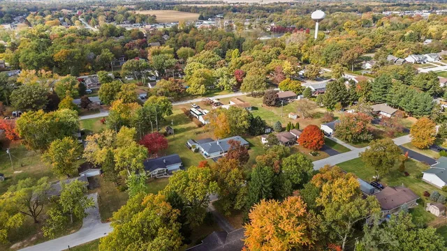 an aerial view of residential houses with yard