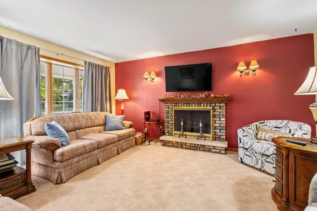 a living room with furniture a flat screen tv and a fireplace